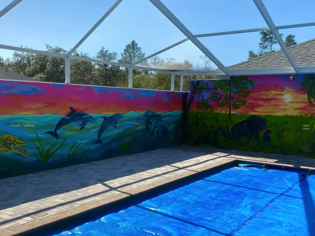 Colorful pool mural with ocean and jungle scenes