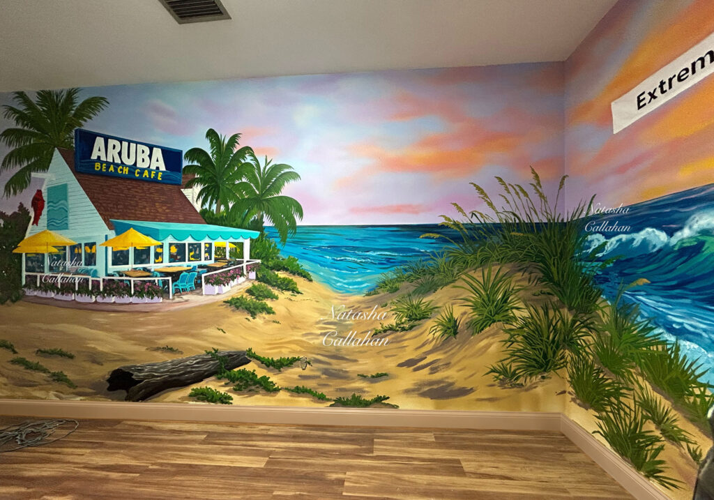 Beach cafe mural with palm trees and ocean waves.