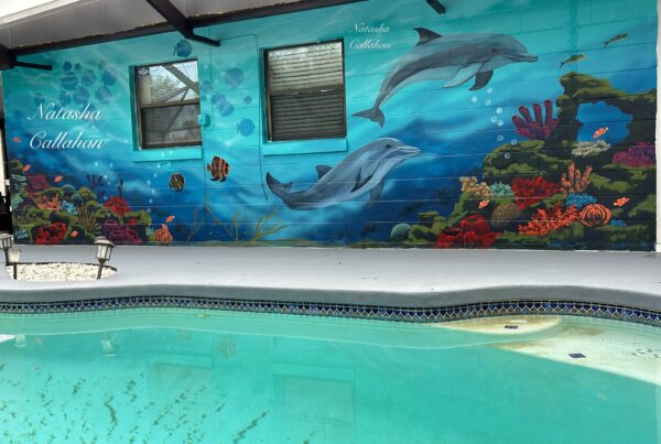 Underwater mural with dolphins and coral reef.